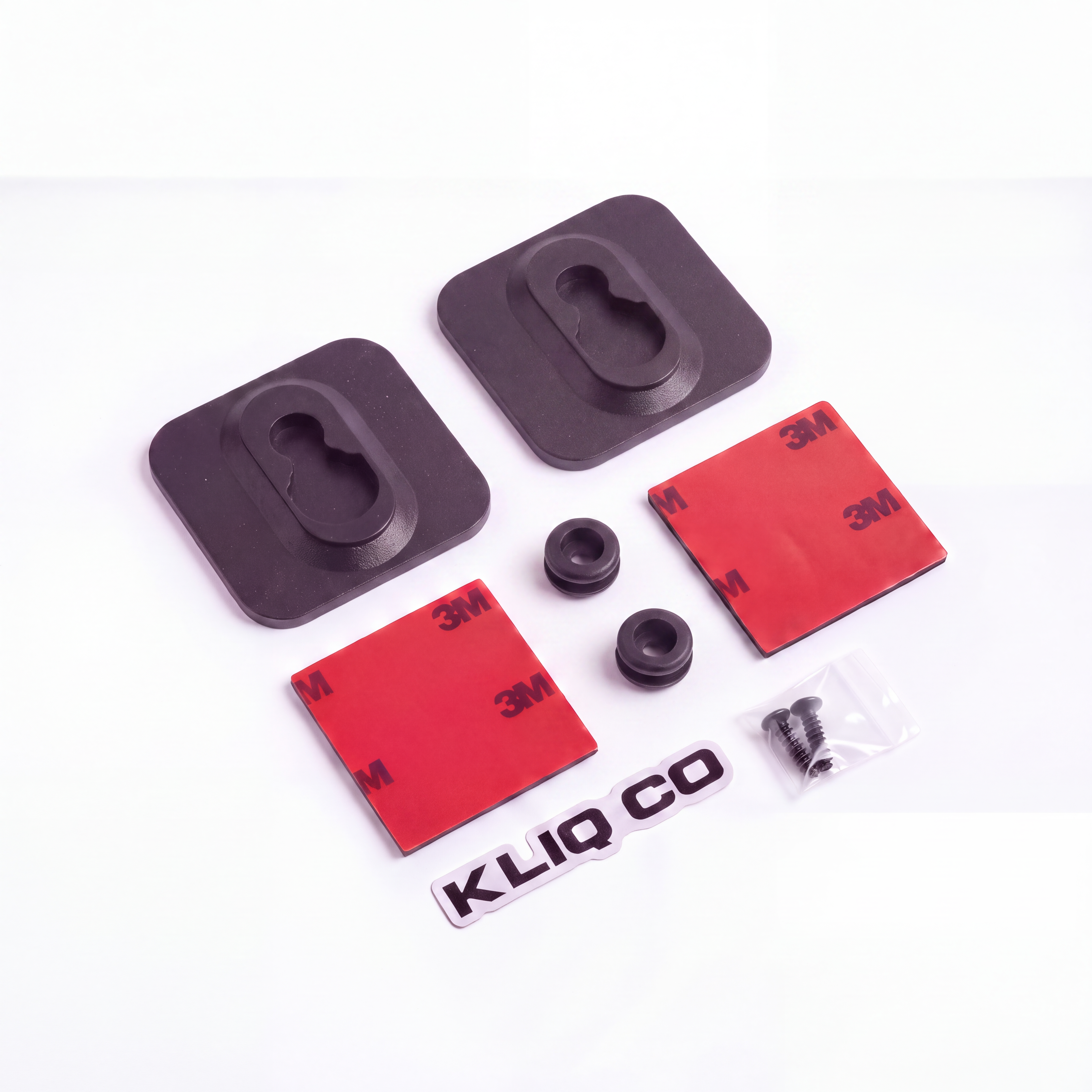 A set of black rubber mounting pads and hardware with two red 3M adhesive pads, two black rubber grommets, a small silver screw, and a white KLIQ CO logo decal, arranged on a white background.