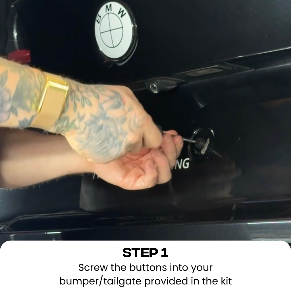 A close-up instructional photo shows a tattooed person's hands installing a small screw into a circular opening on a black car bumper, with text at the bottom reading 'STEP 1 Screw the buttons into your bumper/tailgate provided in the kit.'.