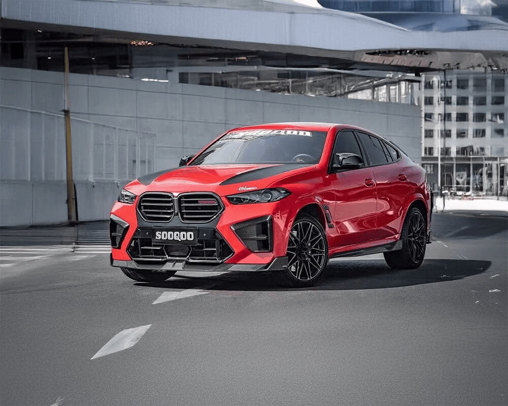 Red BMW X6M F96 SOOQOO car on a city street with modern buildings in the background